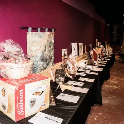 A long table with silent auction items displayed